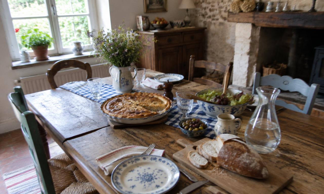 The Sunday table, set ahead of time: the festive tablecloth, the sliced bread, the pastry waiting in the center.